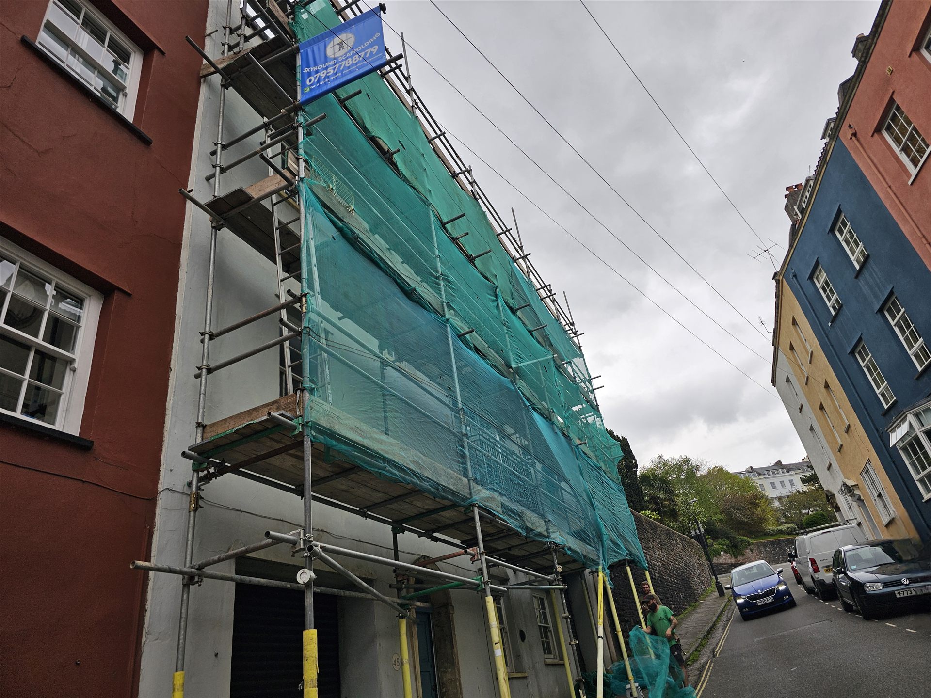 Protective sheeting and scaffold access on a building